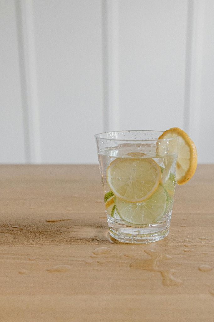 Glass of water with lemon slices representing alkaline water